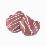 Dos Hojaldre con forma de palmera con crema de avellana cubierto de cobertura negra y decorado con cobertura blanca